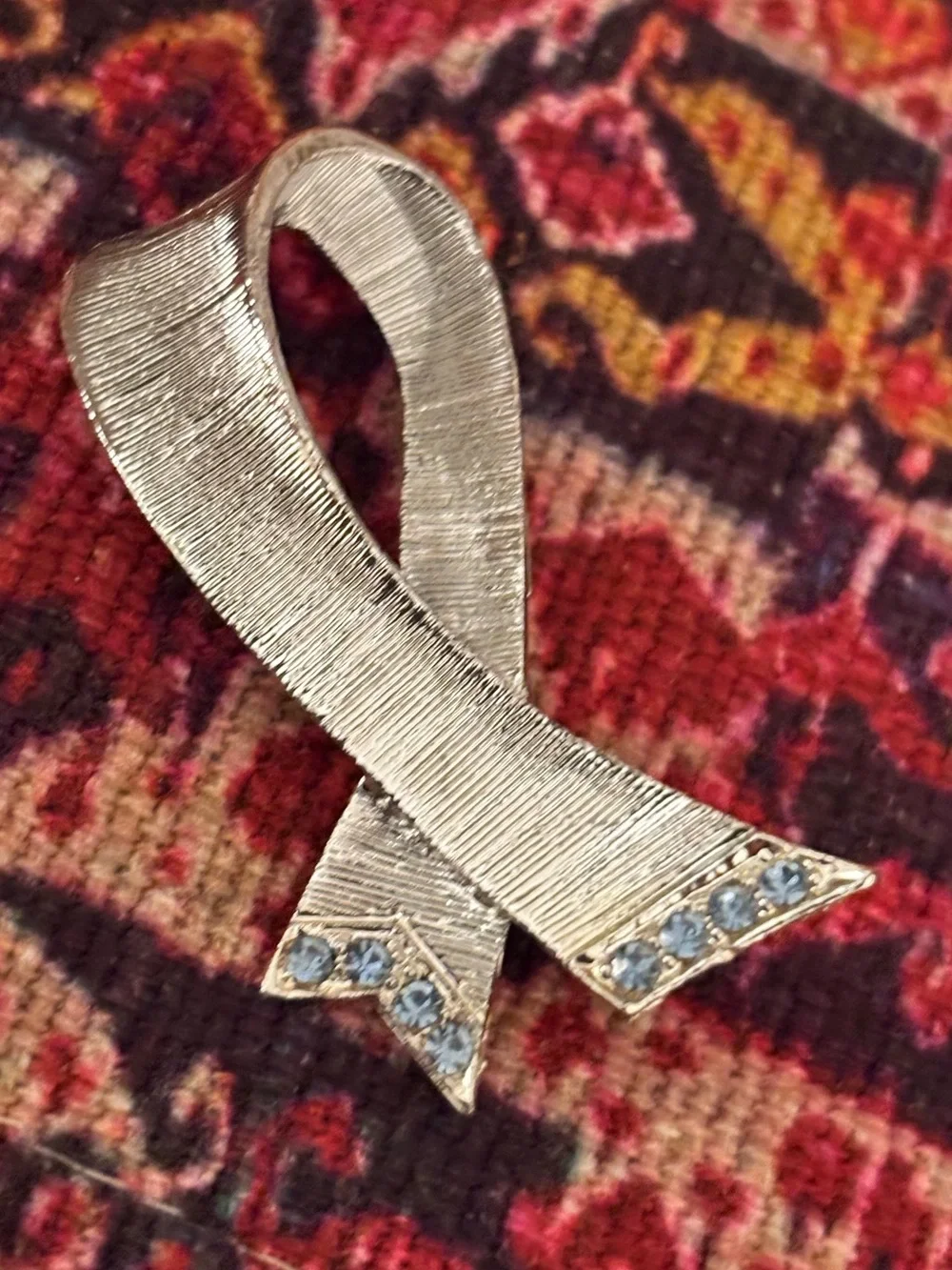 Silver Ribbon Brooch with Light Blue Stones